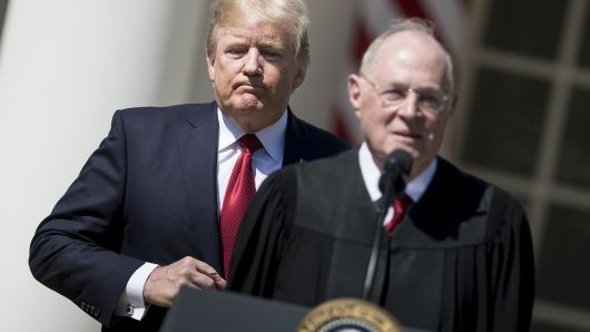 US President Donald Trump (L) listens while Supreme Court Justice Anthony Kennedy speaks during a ceremony in the Rose Garden of the White House April 10, 2017 in Washington, DC.