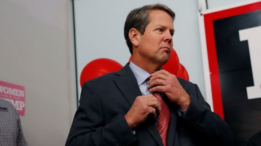 Gubernatorial candidate Brian Kemp adjusts his tie before speaking to volunteers and staff at his campaign office as they hold a phone banking event in Atlanta, Georgia, U.S., November 5, 2018. 