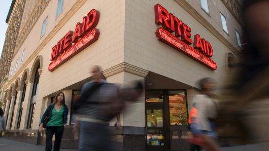 Pedestrians walk past a Rite Aid Corp. store in Oakland, California.